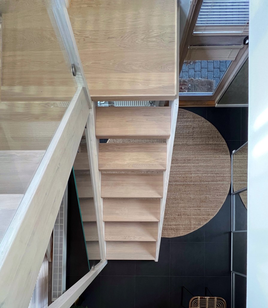 Pyöreä matto eteisessä, musta laattalattia, sisalmatto, eteinen, bungalow-talo